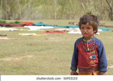 NECHEM, AFGHANISTAN - MAY 28: Young Boy Waits For His Mother On May 28, 2010 In Nechem, Afghanistan. Child Mortality Has Fallen Significantly In The Village Since The WHO Began A Nutrition Program.