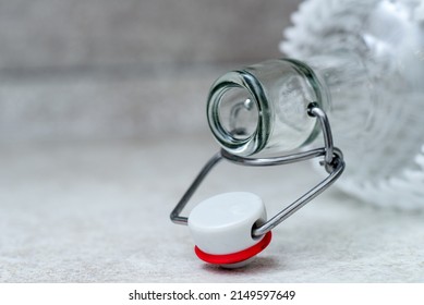 neck of a glass empty bottle with a hinged cork on a gray background. close-up. Space for text. - Powered by Shutterstock