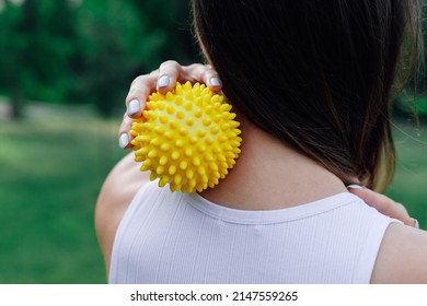 Neck Massage With Spiky Yellow Massage Ball For Muscle Pain Relieve And Myofascial Release. 