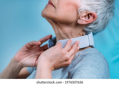 Neck massager. Senior woman getting a neck massage with a massager. - Powered by Shutterstock