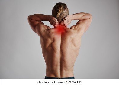 Neck Pain. Athletic Man Massaging His Inflamed Spine. 