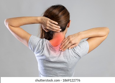 Neck pain, woman with backache on gray background, studio shot