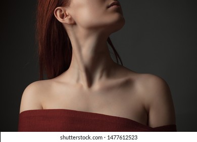 Neck And Shoulders Of Young Woman. Studio