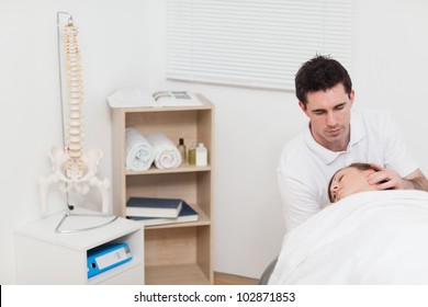 Neck of woman being manipulated by the chiropractor in a medical room
