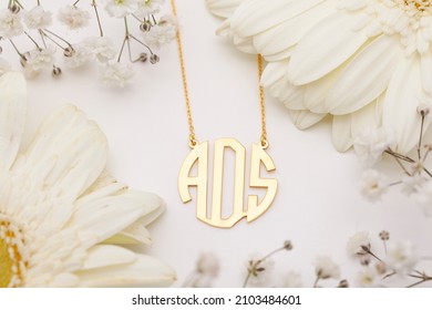 İnitials Necklace On The Flowers Background. Jewelry Images That Can Be Used In E-commerce, Online Sales And Social Media.