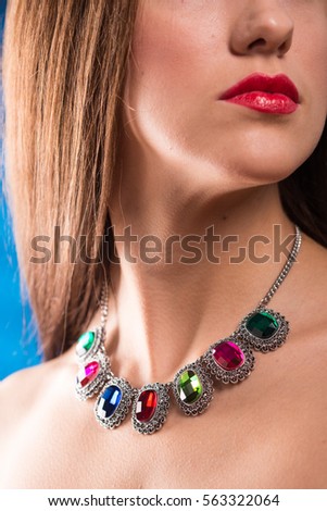 necklace on the neck. ruby and emerald