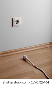 Need extension. White power socket on beige wall at low height from the floor and a short cable