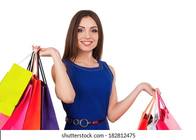 I Need Some Retail Therapy. Attractive Young Woman Holding Shopping Bags And Smiling At Camera