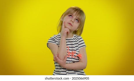 Need To Think. Doubting Pensive Little Blonde Teen Child Kid Girl Pondering And Imagining In Mind, Wondering Difficult Solution, Feeling Confused, Not Sure About Choice On Yellow Studio Background