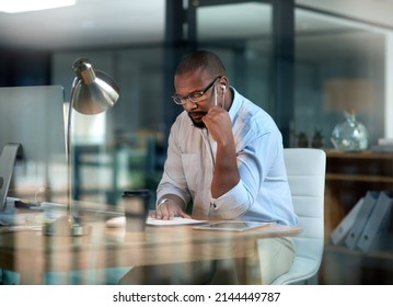 I Need To Work Smart With This Goal, Not Harder. Cropped Shot Of A Mature Businessman Sitting In His Office At Night And Looking Contemplative While Wearing Earphones.