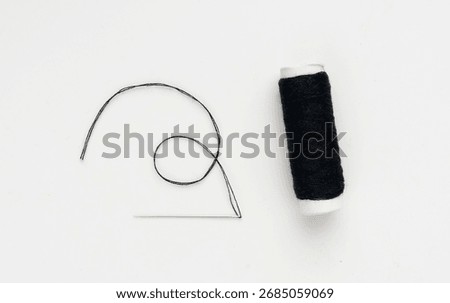 Needle and black thread isolated. Needlework object, color cotton thread spool and needle on white background, craft work material and dressmaking industry symbol
