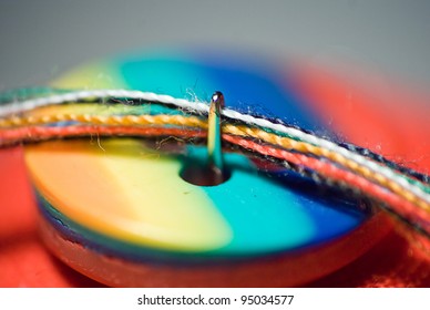 needle and colorful button close up