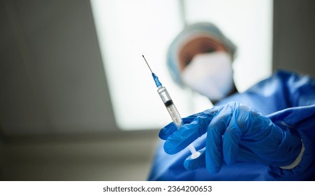 Needle in hand, medicine and doctor person, healthcare and low angle with closeup, surgeon and anesthesia. Mockup space, syringe and gloves for safety, hospital and surgery with medical professional