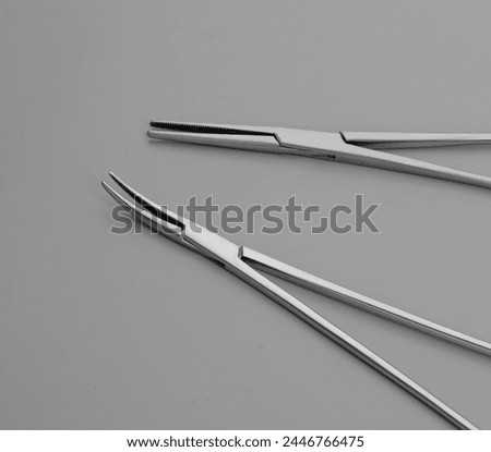 Needle holders and kelly forceps. Medical forceps. Forceps used for medical purposes. 