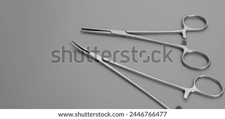 Needle holders and kelly forceps. Medical forceps. Forceps used for medical purposes. 