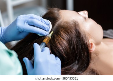 Needle mesotherapy. Cosmetic been injected in woman's head. to s