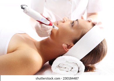 Needle mesotherapy.Beautician performs a needle mesotherapy treatment on a woman's face