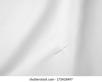 Needle On White Fabric