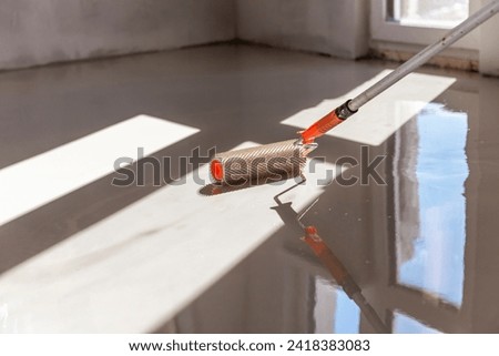 Needle roller for self-leveling floors. Leveling the floors with a cement mixture.