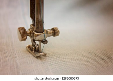 The needle of the sewing machine close-up.