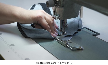 needle of the sewing machine in motion, close-up. needle of sewing machine quickly moves up and down. process of sewing leather goods. Tailor sews black leather in sewing workshop. - Shutterstock ID 1439204645