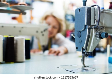 Needle with thread in automatic sewing machine on factory, closeup view