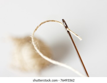 Needle with thread with ball on background - Shutterstock ID 76493362