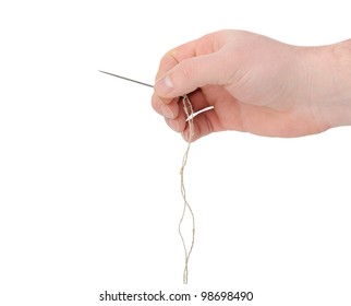 Needle And Thread In Hand Closeup. Isolated On White Background