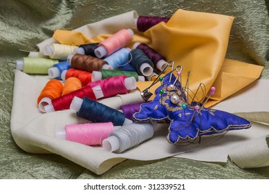 needle and thread on background fabrics for sewing