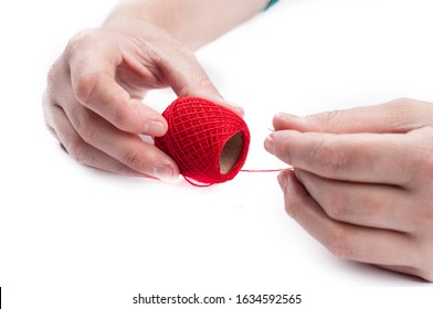 Needle and thread in woman's hand isolated on white background.Copy space - Shutterstock ID 1634592565