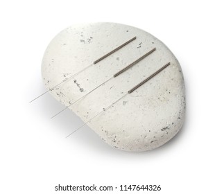 Needles For Acupuncture And Stone On White Background