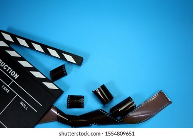  Negative Film And Clapperboard On Blue Background And Copy Space Video Or Movie Editor Concept                               