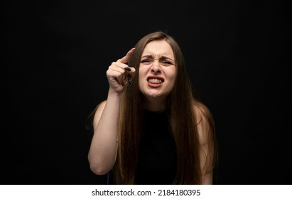 Negative Human Emotions And Feelings. Grumpy Angry Young Woman Posing, Frowning Eyebrows, Her Look And Grimace Expressing Anger, Annoyance.