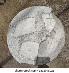 Negeri Sembilan, Malaysia - Oct 4, 2020: top view of a broken stone stool under a bright sunny day with brown sand as background