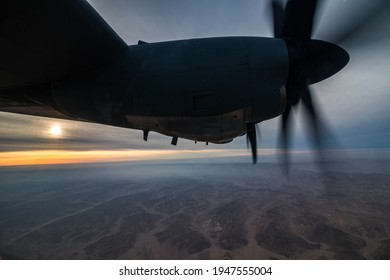 Negev Desert, Israel - January 10, 2018: Wing view of a C-130J "Super Hercules" transport aircraft of the Israeli Air Force flying at sunset over the Negev Desert