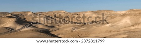 Negev desert panorama with a Bedouin settlement near the tourist resort Kfar Hanokdim between Arad and Masada in Israel.