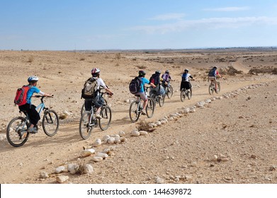 NEGEV,ISR - MAY 31 2009:Group of Israeli people cycle in the Negev Desert.Various peoples have lived in the Negev since the dawn of history such as:Nomads, Canaanites, Nabateans and Israelis.