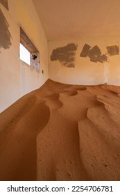 Neglected house interior with blue walls buried in the sand in Al Madam ghost village in United Arab Emirates. - Shutterstock ID 2254706781