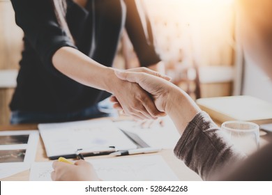 Negotiating business,Image of businesswomen Handshaking,happy with work,the woman she is enjoying with her workmate,Handshake Gesturing People Connection Deal Concept - Shutterstock ID 528642268