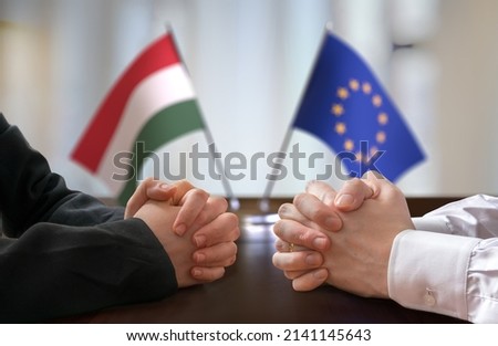 Negotiation between Hungary and European Union. Hungarian and European flags in background.