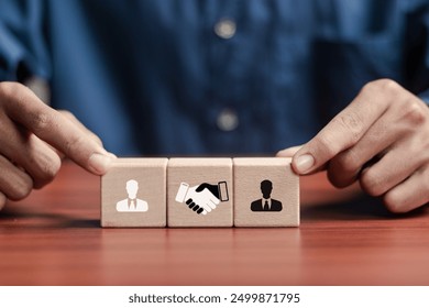 Negotiation concept. Wooden block with handshake icon and businessman icon for negotiation, agreement, cooperation, business partnership. - Powered by Shutterstock