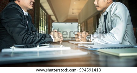 Negotiation of two statesman with clasped hands in office. Two men's hand on a desk. Negotiating business concept.