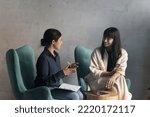 Negotiations of two multi ethnic businesswomen in modern office. Indian female applicant pass job interview, answers to HR manager during formal meeting in workspace. Teamwork, business, communication