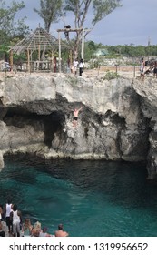 NEGRIL (RICK´S CAFE), JAMAICA - MAY 27. 2010: Cliff Diving Into Blue Lagoon From Height 8 To 40 Feet