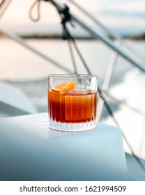 Negroni Cocktail With A Large Ice Cube On A Boat (yacht)