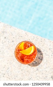 Negroni Cocktail  Near A Pool At The Resort Bar Or Suite Patio. Luxury Resort, Vacation, Room Service Concept. Overhead Shot. Vertical