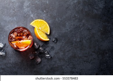 Negroni cocktail on dark stone table. Top view with space for your text - Shutterstock ID 553378483