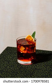 Negroni, An Italian Cocktail, An Apéritif, First Mixed In Firenze, Italy, In 1919. Garnished With Charred Orange And Sage Leaf