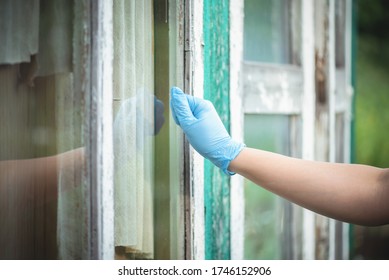 A Neighbor In The Medical Glove Knocks On The Window.