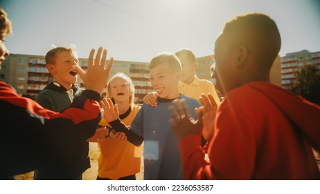 Neighborhood Kids Playing Soccer in Eastern European Backyard. Young Football Players Dribbling, Passing Ball, Scoring a Goal. Boys and Girls Celebrate the Victory. Wide Shot. - Powered by Shutterstock